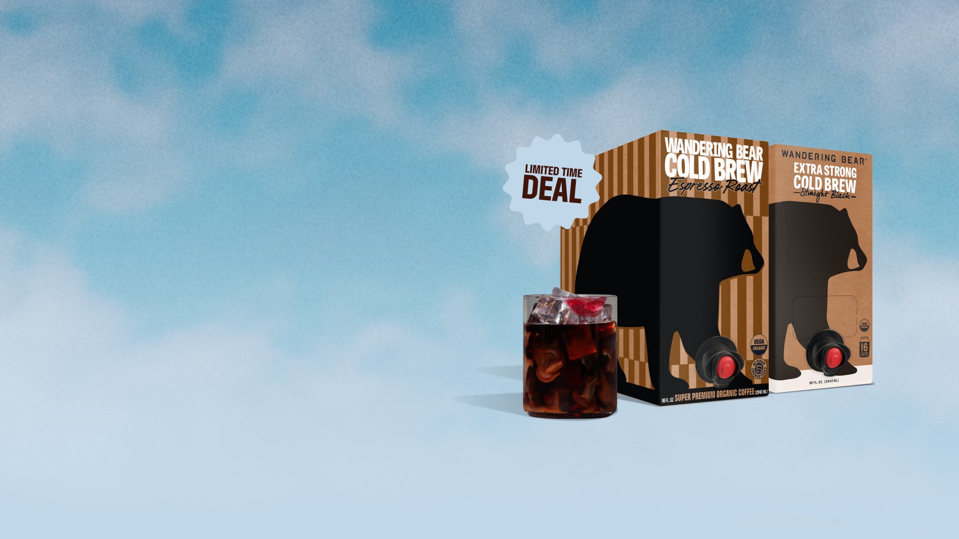 Three-quarter view of two Wandering Bear Cold Brew 96 oz boxes (Espresso Roast and Straight Black) with pour spouts, an iced glass, and a 'Limited Time Deal' badge on a blue sky background