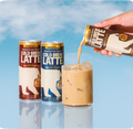 Cold brew latte cans in mocha, vanilla, and double latte flavors, with one poured over ice against a blue background